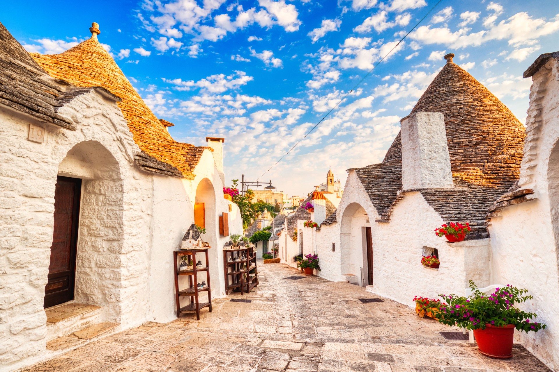 Famous Trulli Houses during a Sunny Day with Bright Blue Sky in Alberobello, Puglia, Italy Famous Trulli Houses during a Sunny Day with Bright Blue Sky in Alberobello, Puglia, Italy